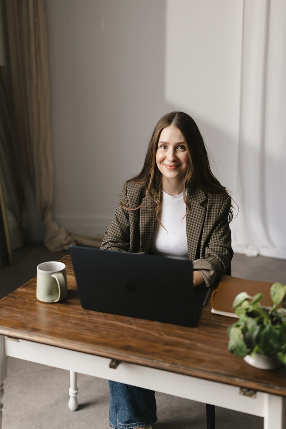 Sara at a desk with a laptop